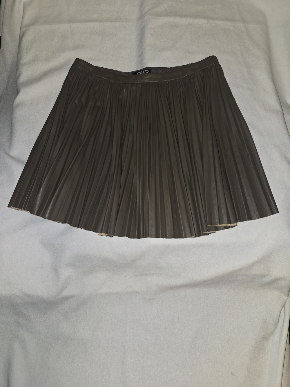 Swingy pleated mini skirt in faux leather